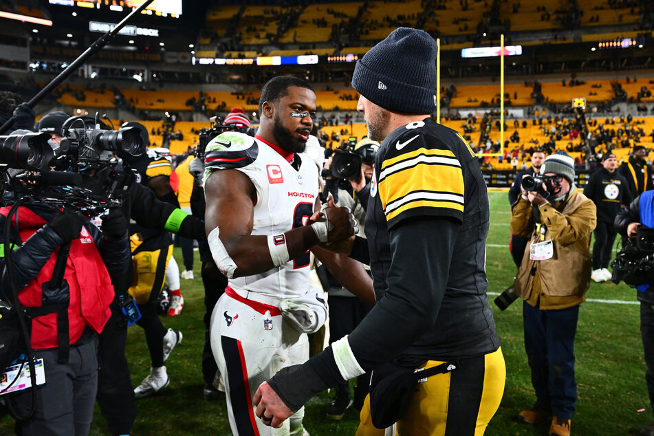 Azeez Al-Shaair of the Houston Texans wears the message "Stop the Genocide" on his eye black as he shake hands with Aaron Rodgers of the Pittsburgh Steelers after an NFL wild card playoff game at Acrisure Stadium on January 12, 2026.