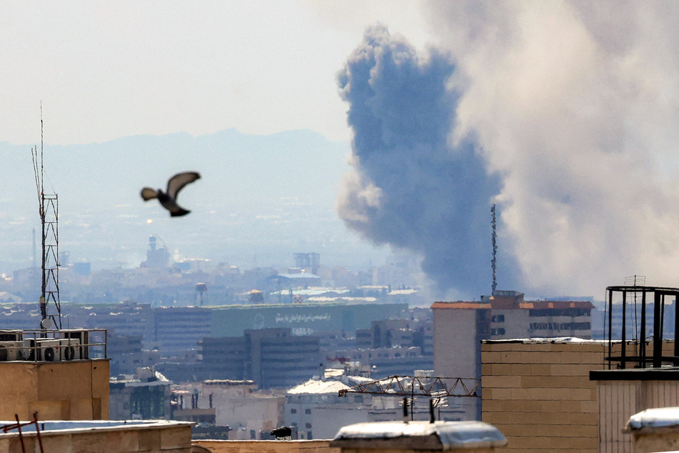 Smoke rises following strikes on Tehran on Tuesday.