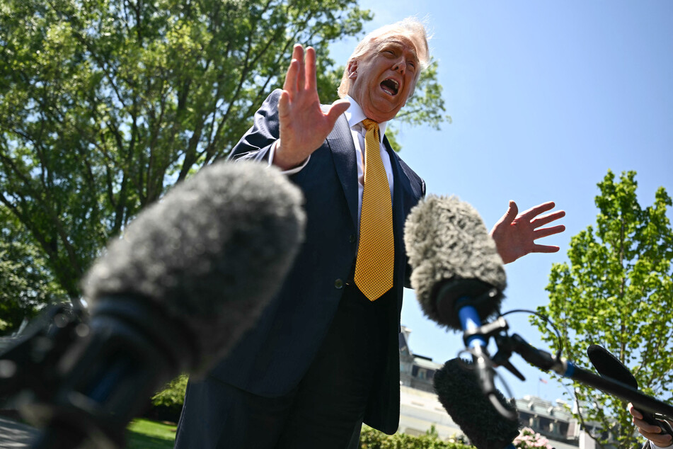 President Donald Trump speaks to the press before walking to board Marine One as he departs from the South Lawn of the White House in Washington, DC, on May 12, 2026.