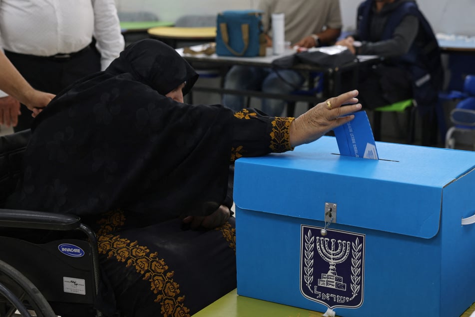 An elderly woman casts her ballot at a polling station in the southern bedouin city of Rahat on October 27 during Israel's legislative election. Exit polls did not indicate a clear winner in the closely-watched race.