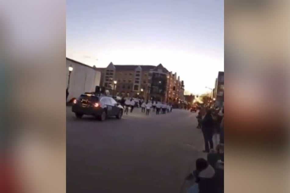 Screams can be heard as the SUV smashes into the parade.