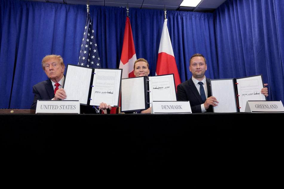 From l. to r.: US President Donald Trump, Danish Prime Minister Mette Frederiksen, and Greenland Prime Minister Jens-Frederik Nielsen show signed documents regarding a deal on Greenland, during the 81st United Nations General Assembly in New York City on September 22, 2026.