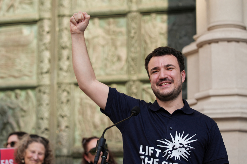 Mahmoud Khalil raises his fist during a rally to welcome him home after his release from immigration detention, outside the Cathedral of St. John the Divine in New York City, on June 22, 2025.