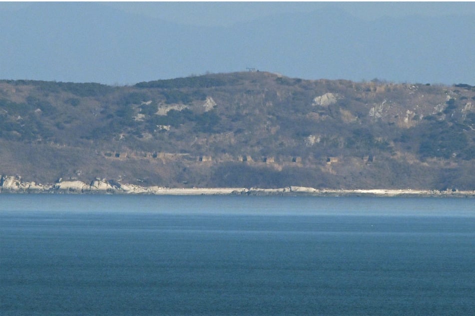 A view of North Korea's coastline with artillery bunkers from Yeonpyeong island, where North Korea fired over 60 artillery rounds on Saturday, according to Seoul's military.