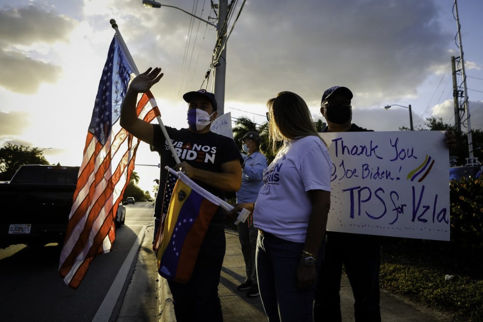 Venezuelans gather to celebrate the granting of TPS by President Joe Biden in front of El Arepazo restaurant in Miami, Florida, on March 9, 2021.