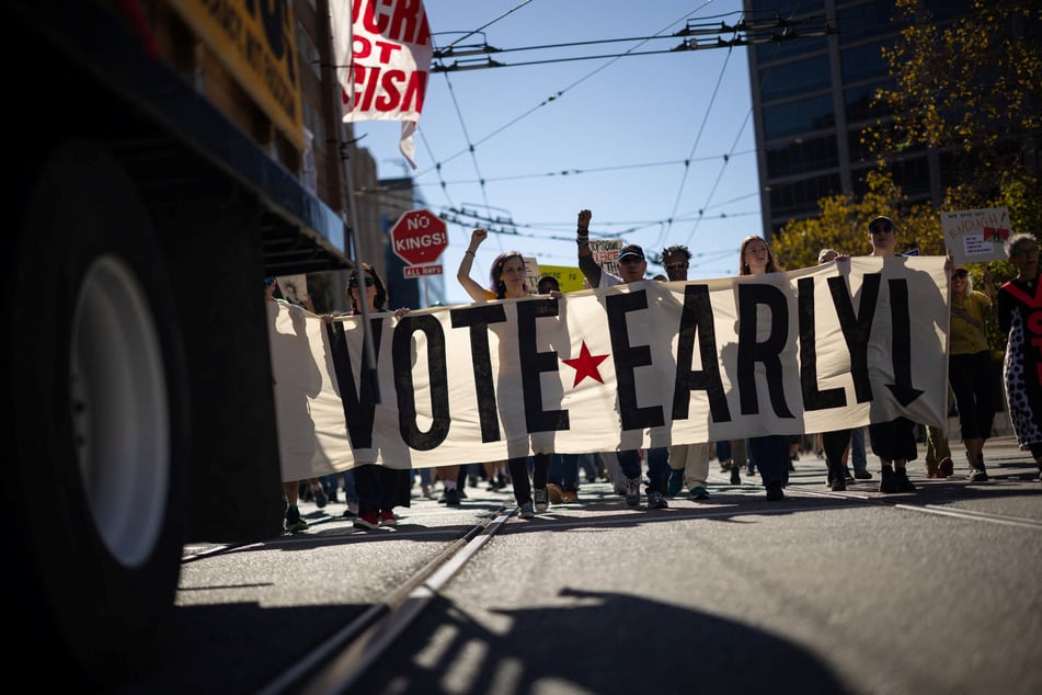 People march with a "Vote Early" banner during a No Kings protest ahead of the midterm elections in San Francisco, California, on October 17, 2026.
