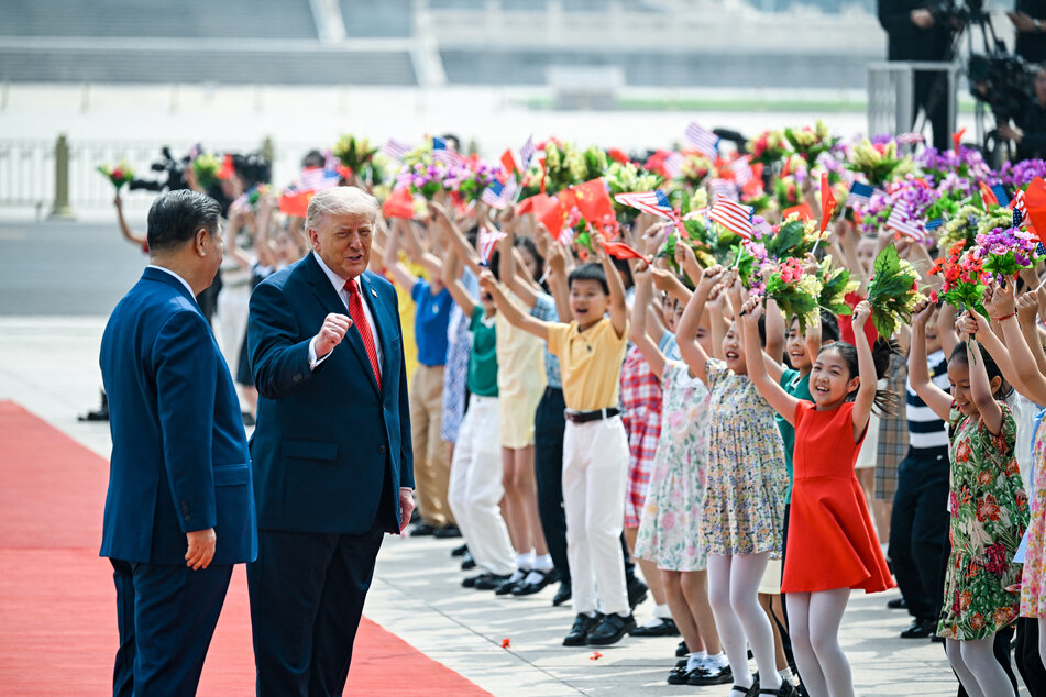 President Donald Trump was greeted by Chinese President Xi Jinping to with an opulent red-carpet walk and a host of chanting schoolchildren.