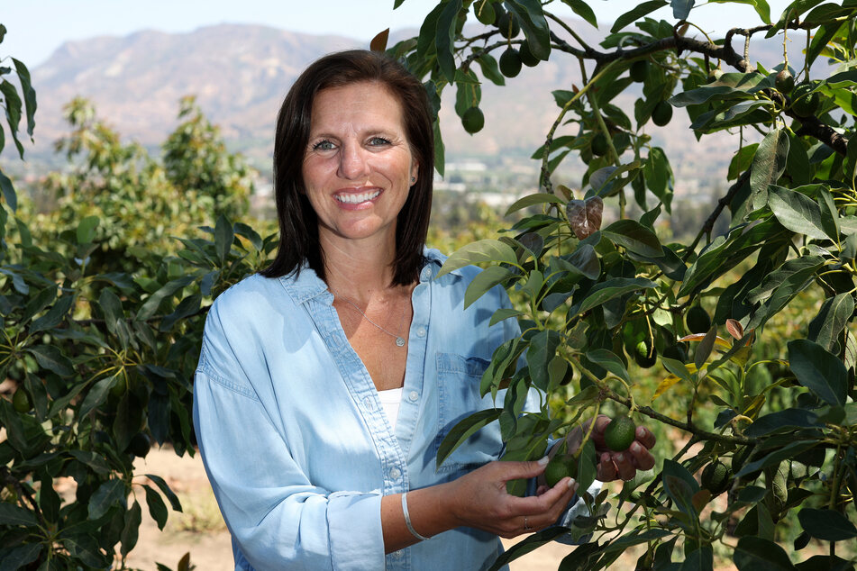 Lisa Tate Soury, owner of Rancho Filoso Farm, poses near avocado trees on her farm in Santa Paula, California.