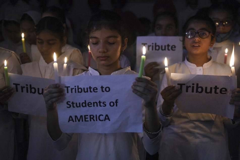 Students hold candles in tribute to the victims of a mass shooting in Uvalde, Texas.
