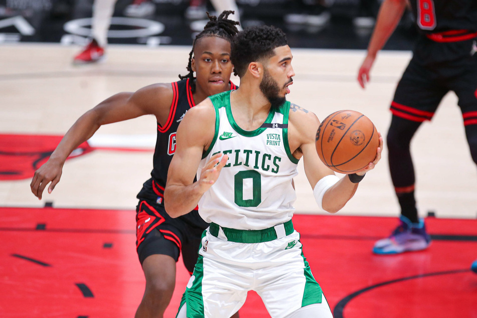The Celtics' Jayson Tatum being guarded by the Bulls' Ayo Dosunmu.