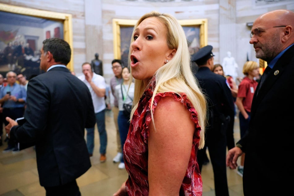 Rep. Marjorie Taylor Greene saying, "Hold the trial," as she and her fellow Republican impeachment managers walk back through the US Capitol Rotunda on April 16, 2024.