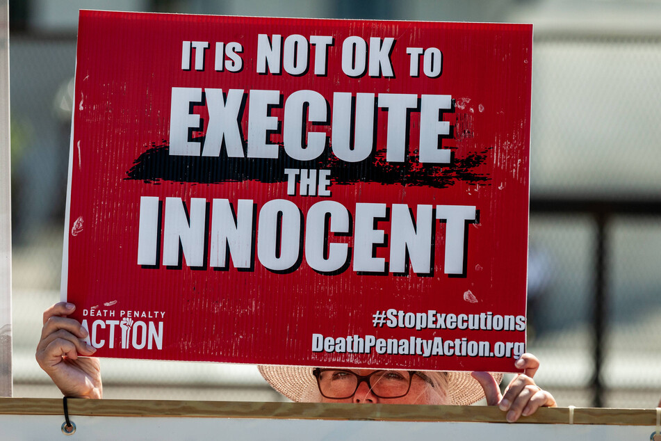 A protester holds a sign during a vigil outside the US Supreme Court to abolish the death penalty on June 29, 2022.