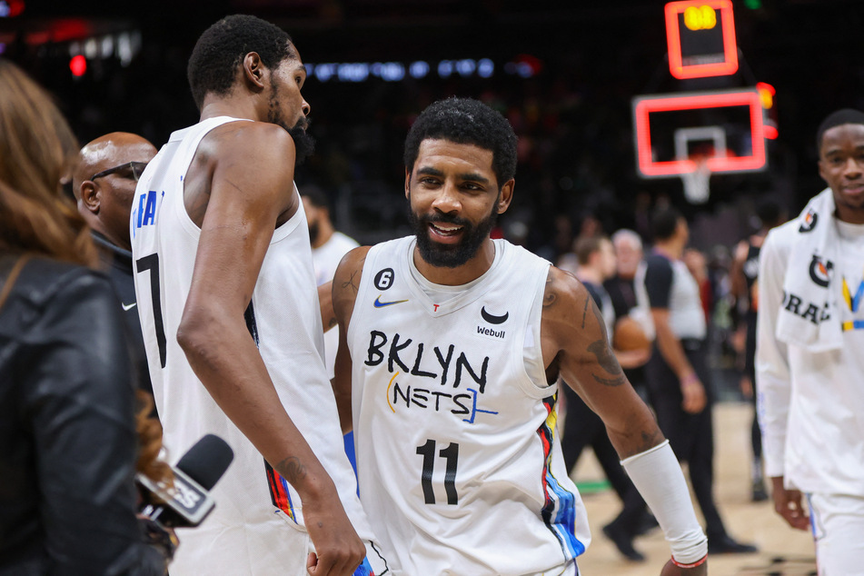 Kevin Durant (l.) and Kyrie Irving celebrate another Nets win, which brings their streak to 10 in a row.