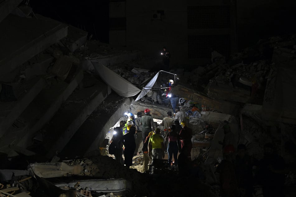 Rescuers search for possible victims at a collapsed building following the twin earthquakes, in Caraballeda, La Guaira State, some 40 km northeast of Caracas, on Saturday.