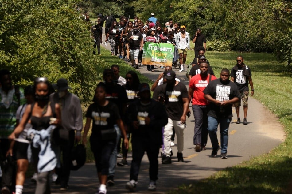 Activists march in Arlington, Virginia, for an end to the filibuster to pass federal legislation on voting rights, DC statehood, and reparations.