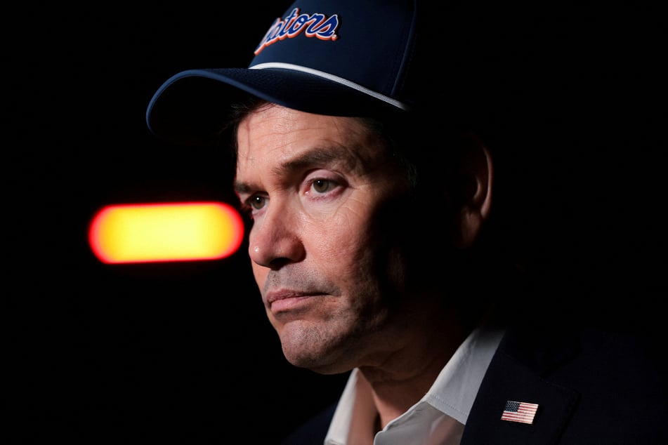 Secretary of State Marco Rubio prepares to board a plane en route to Samarkand, Uzbekistan, at Joint Base Andrews, Maryland, on October 17, 2026. Speaking to reporters, he dismissed criticisms of a new executive order waiving sanctions and tariffs on Russia.