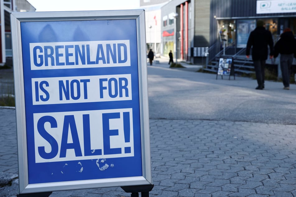 A sign reading "Greenland is not for sale!" is pictured in Nuuk on September 22, 2026. Donald Trump has announced that oil, gas, and mineral exploration is due to begin on the Arctic island.