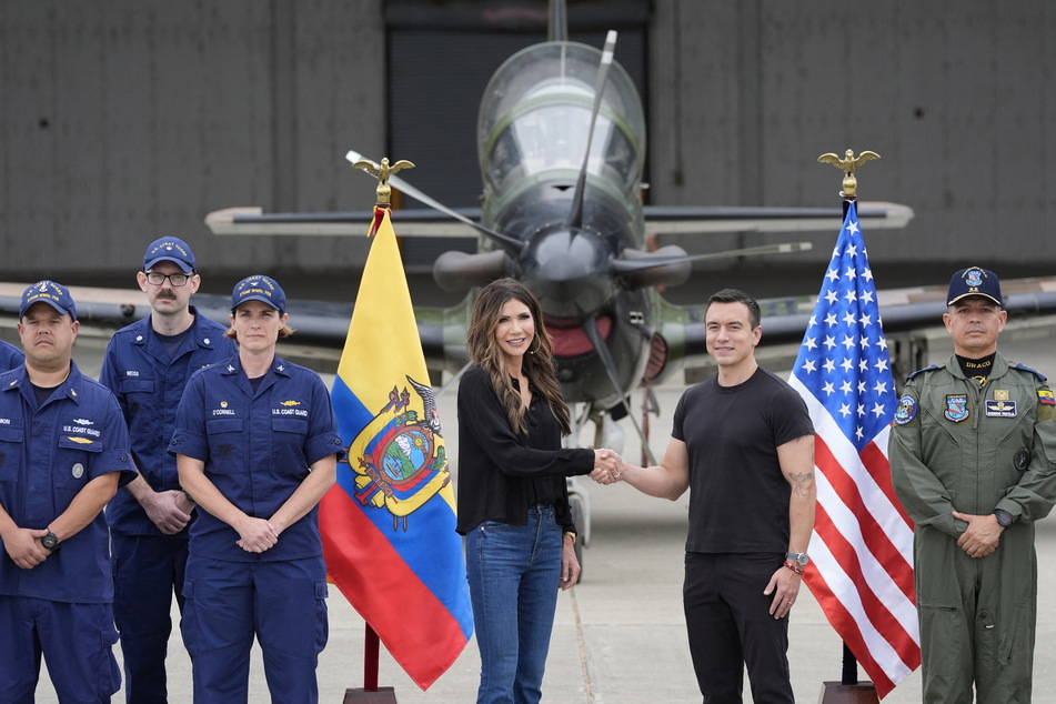 US Homeland Security Secretary Kristi Noem (center left) and Ecuador's President Daniel Noboa (center right) shake hands at the Eloy Alfaro Air Base in Manta, Ecuador, on November 5, 2025.