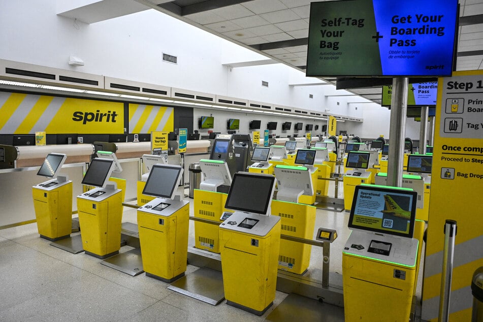 The self-service check-in kiosks of Spirit Airlines stand idle with a message to customers after the company ceased global operations at Fort Lauderdale-Hollywood International Airport on May 2, 2026.