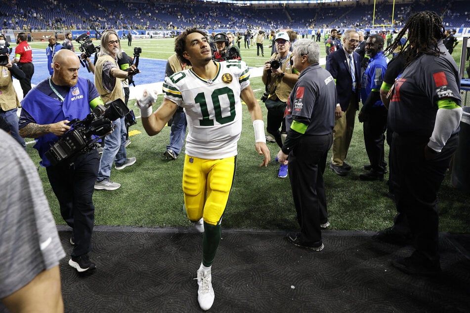 Jordan Love #10 of the Green Bay Packers runs off the field after defeating the Detroit Lions on Thursday in Detroit, Michigan.