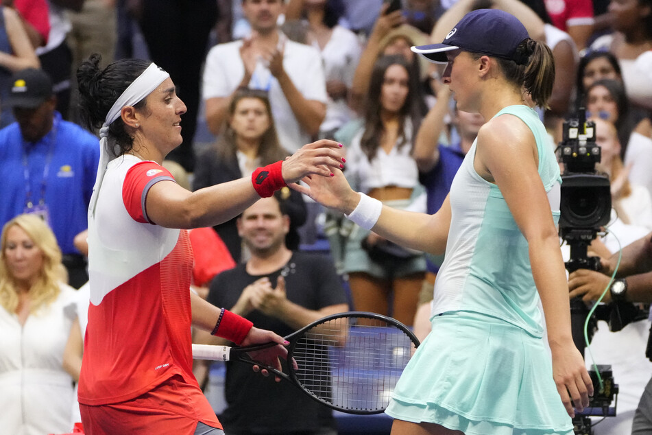Swiatek and Jabeur hug after their match in the women's singles final.