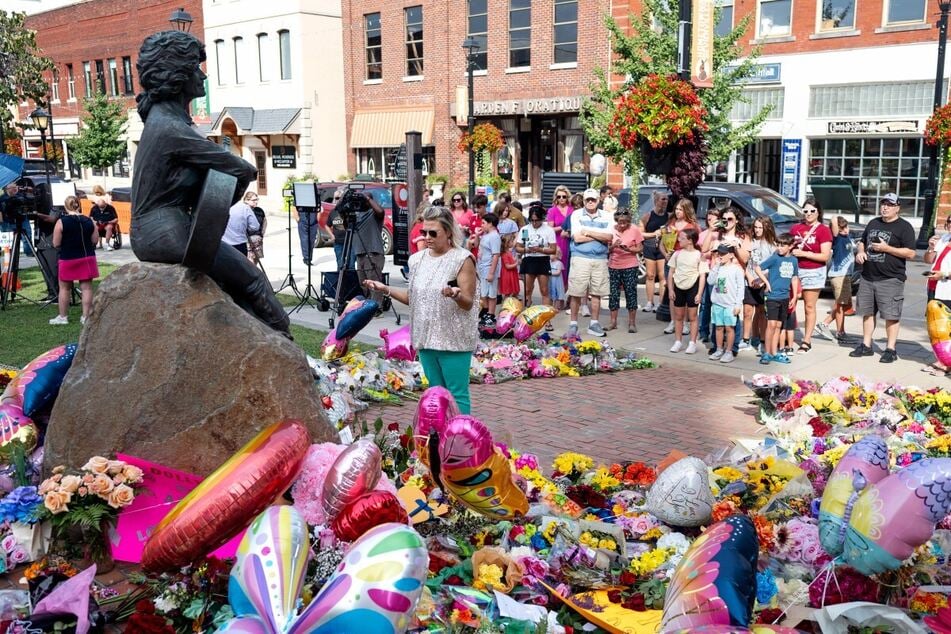 Fans gather at the Dolly Parton Statue in Parton's hometown of Sevierville, Tennessee on August, 26, 2026.