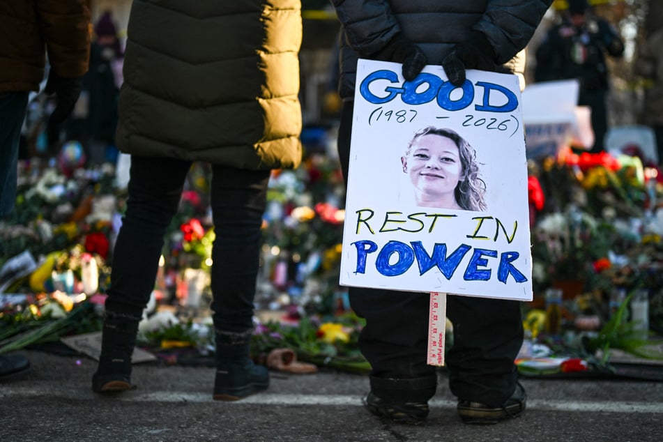 A person holds a sign reading "Good Rest in Power" on January 14 during a vigil near the site where Renee Good was killed in Minneapolis, Minnesota.