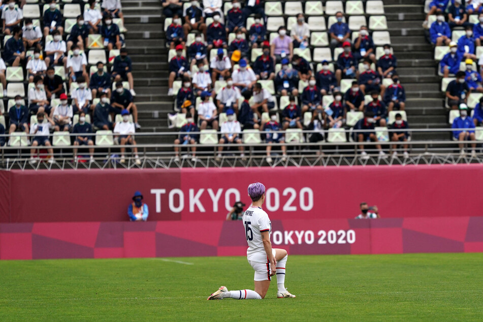 USWNT star Megan Rapinoe taking a knee before her team's match against Australia.