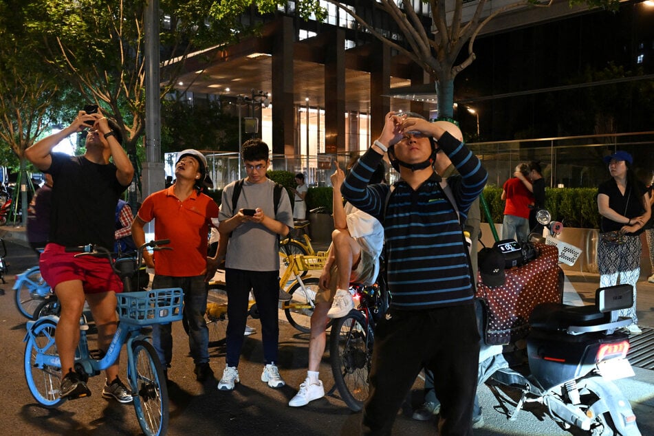 Local residents rushed to capture footage of the incident.