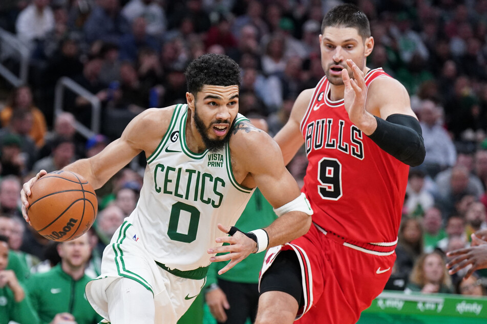 Boston Celtics forward Jayson Tatum drives the ball against Chicago Bulls center Nikola Vucevic in the second half at TD Garden.