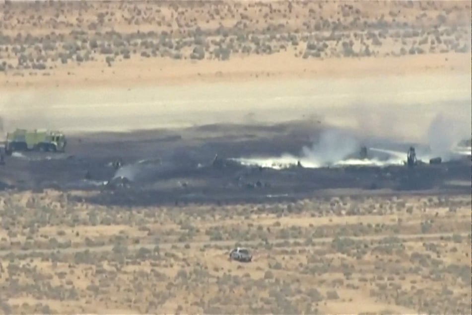 Smoke rises from a blackened part of Edwards Air Force Base after the crash of a US Air Force B-52 bomber in Edwards, California, on June 15, 2026, in a still image from news helicopter video.