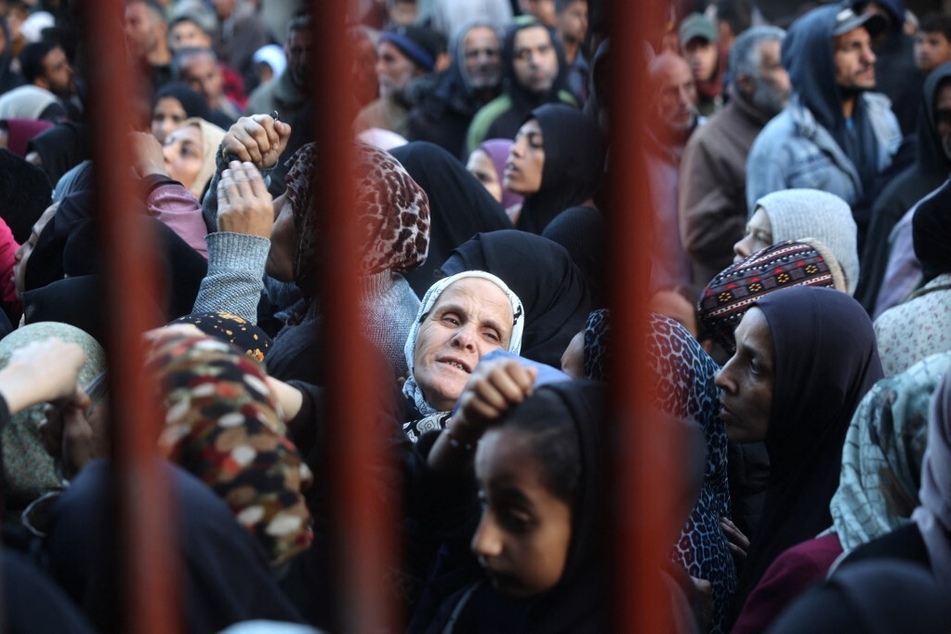 Palestinians wait for bread outside a bakery in the Nuseirat camp in central Gaza on November 27, 2024.