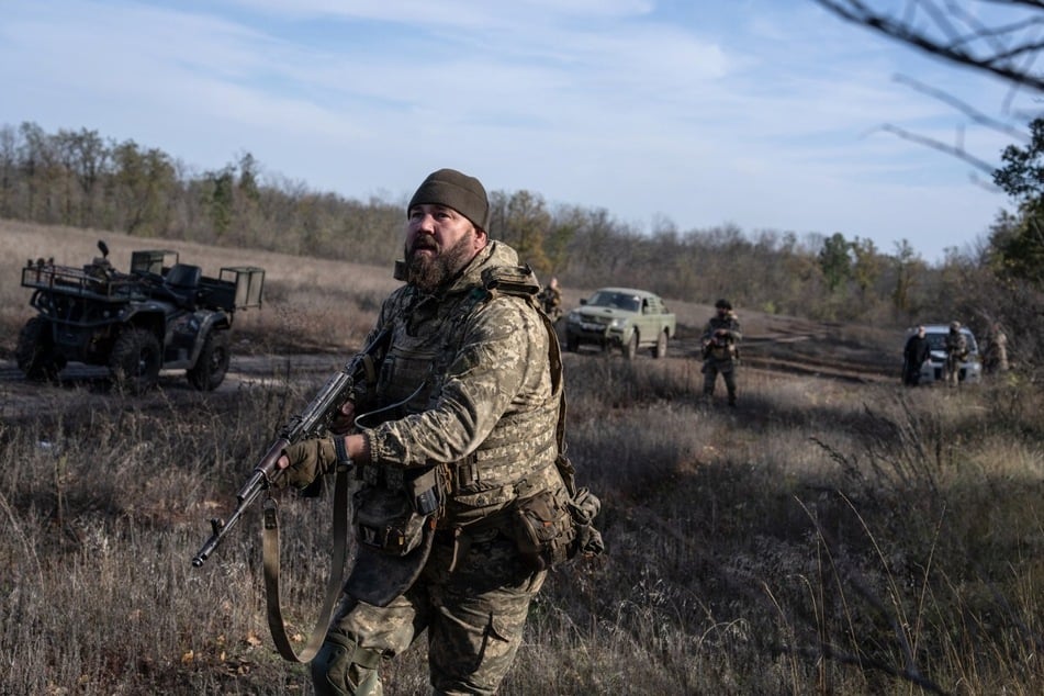 This handout photograph, taken on October 27, 2026, shows servicemen patrolling near the frontline city of Kramatorsk, Donetsk region, amid the Russian invasion of Ukraine. Russia attacked central Ukraine with a "horrific" drone strike on a train station on October 29, 2026, roughly four years after the invasion started.