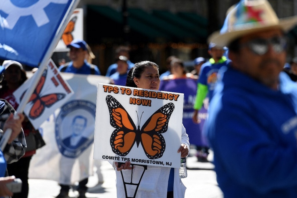 TPS families and supporters march for residency protections near the White House on September 23, 2022.
