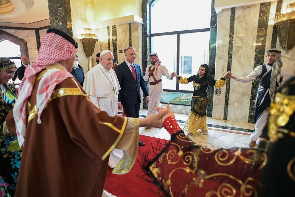 Pope Francis was welcomed by Iraqi President Barham Saleh at the presidential palace in Baghdad.
