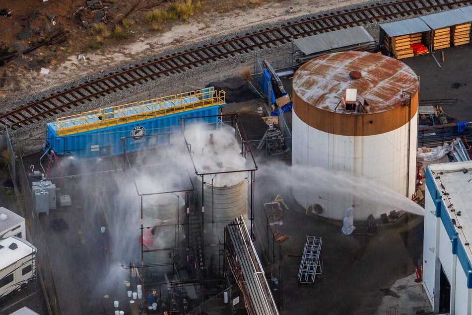 California fire officials said Monday the threat of a toxic chemical tank explosion had been "eliminated," but evacuation orders remain in effect.