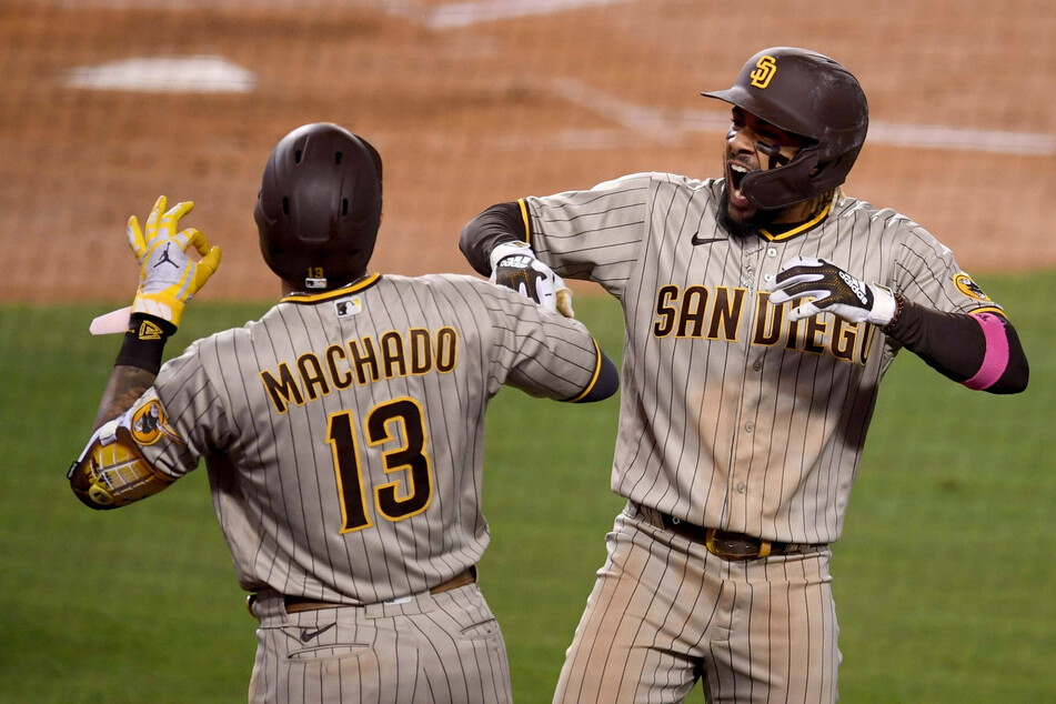 Fernando Tatis Jr. (r.) of the San Diego Padres celebrates with teammate Manny Machado after hitting a solo home run in the fifth inning of their win over the Los Angeles Dodgers.
