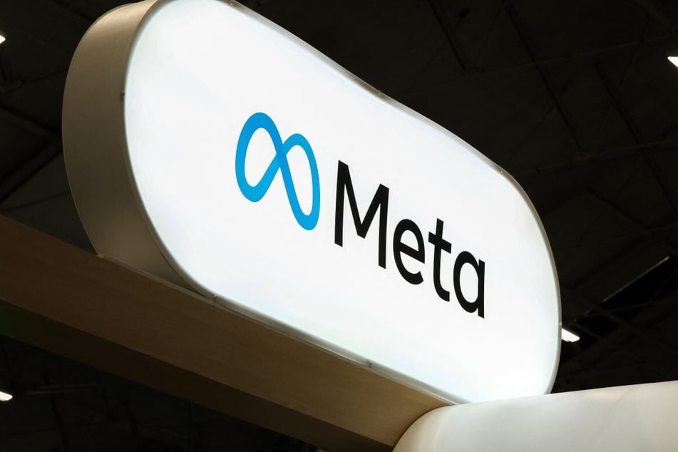 Meta logo seen on a sign at an AI conference in October 2026. The media company is facing backlash and a new investigation over its new terms of service. 