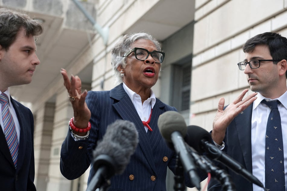 Representative Joyce Beatty, ex officio member of the Kennedy Center Board of Trustees, speaks to the media next to lawyers Joshua Kolb and Nathaniel Zelinsky on the day of a hearing on a new legal challenge that seeks to block Donald ‌Trump's name from being inscribed on the John F. Kennedy Center for the Performing Arts on August 27, 2026.