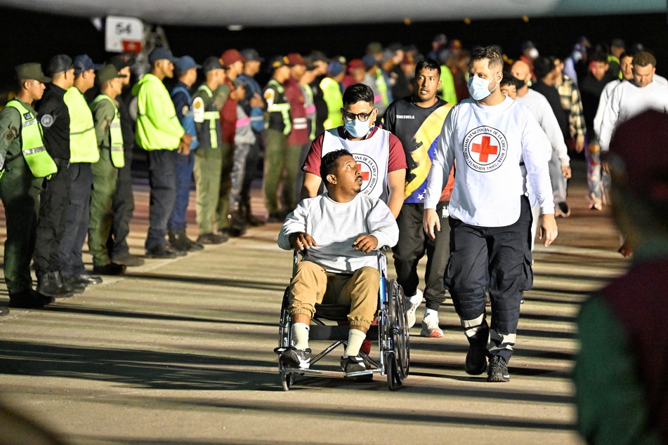 Venezuelan migrants deported from the US and stranded in Honduras disembark from a Conviasa Airlines plane upon arrival at Simon Bolivar International Airport in Maiquetia, Venezuela on March 24, 2025.