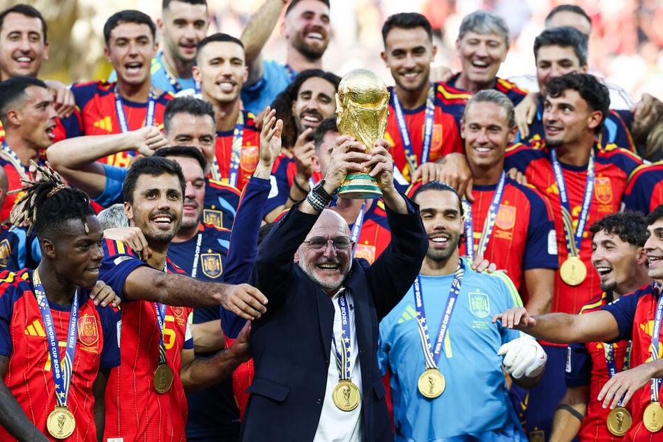 Spain's head coach Luis de la Fuente holds aloft the World Cup trophy after a stunning victory on Sunday.