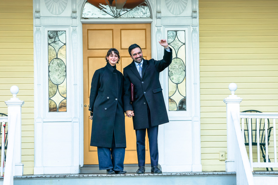 New York City Mayor Zohran Mamdani (r.) and his wife, Rama Duwaji, pose for photos during moving day at Gracie Mansion on January 12, 2026.