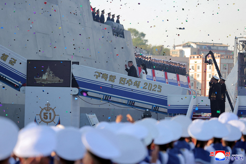 North Korean leader Kim Jong Un, accompanied by his daughter Kim Ju Ae, attends a ceremony for the launch of a "new multipurpose destroyer."