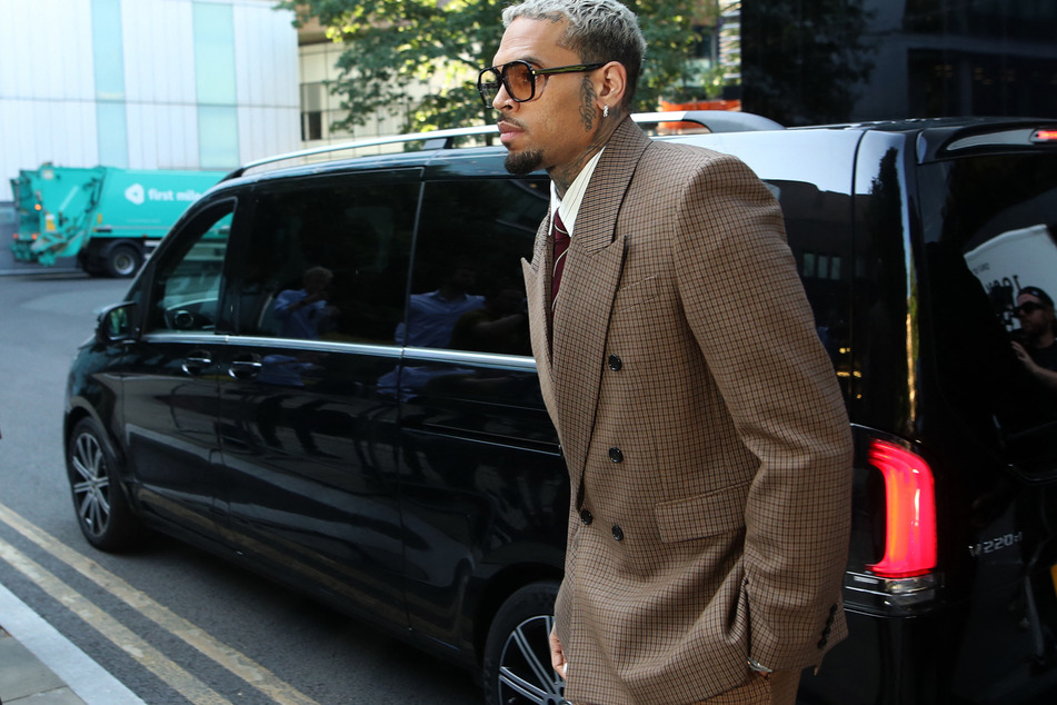 Chris Brown arrives at Southwark Crown Court in London on Friday to attend a plea hearing in the case against him for attempting to cause grievous bodily harm with intent during an alleged London nightclub brawl in 2023.