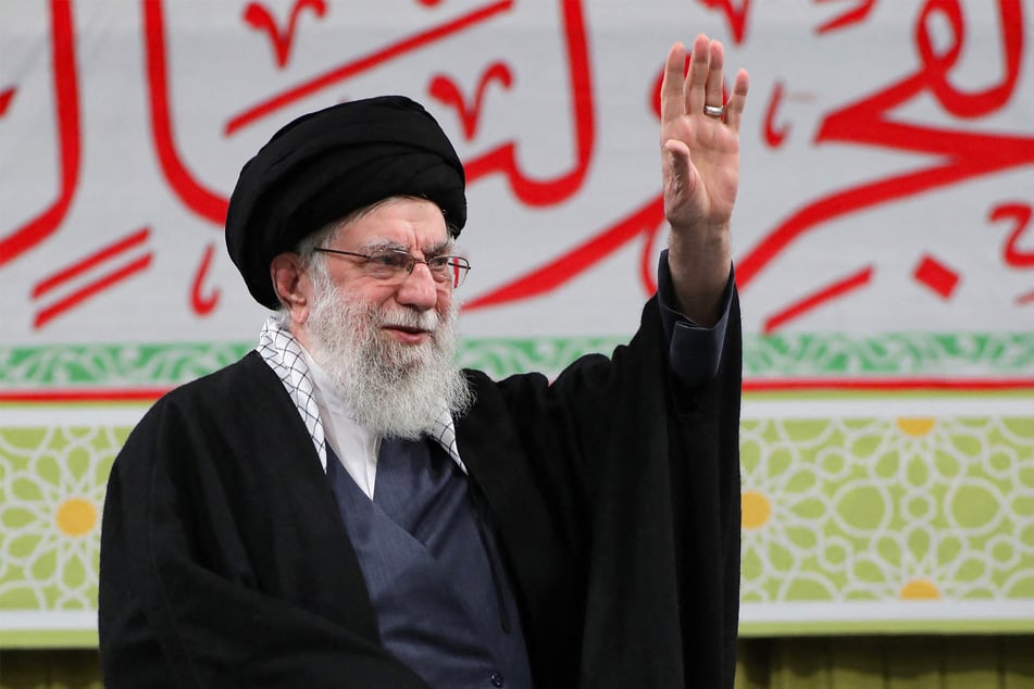 Iran's Supreme Leader Ayatollah Ali Khamenei waves during a meeting in Tehran on February 1, 2026, ahead of the 47th anniversary of the 1979 Islamic Revolution.
