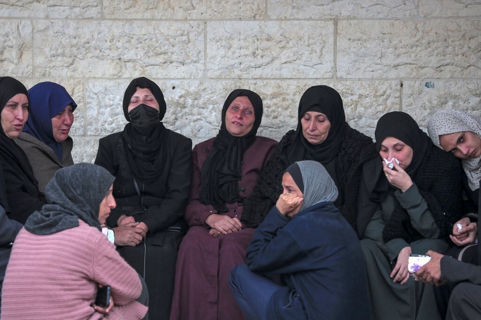 Palestinians react at the Al-Aqsa Martyrs Hospital in Deir al-Balah where relatives pulled from the rubble of the Tabatibi family home were transported on March 16, 2024.