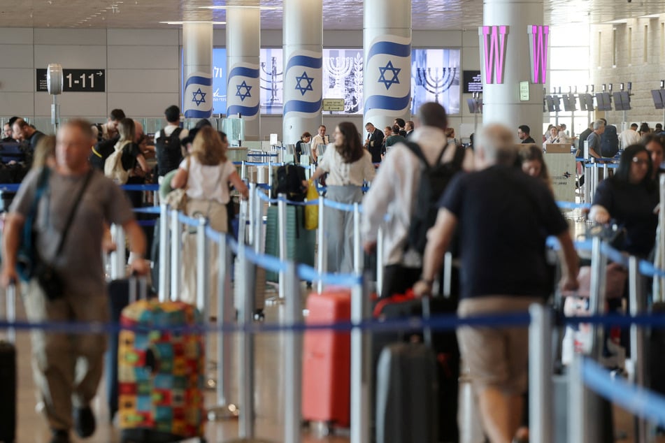 People line up at Ben Gurion International Airport after the FlyDubai aircraft was diverted to Saudi Arabia on Wednesday. Passengers recalled things getting "out of control" on the plane as a co-pilot attempted to crash the flight.