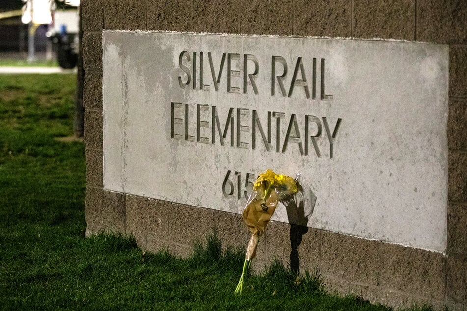 Flowers placed in front of the SIlver Rail Elementery school sign, where four people were killed in a school shooting. 