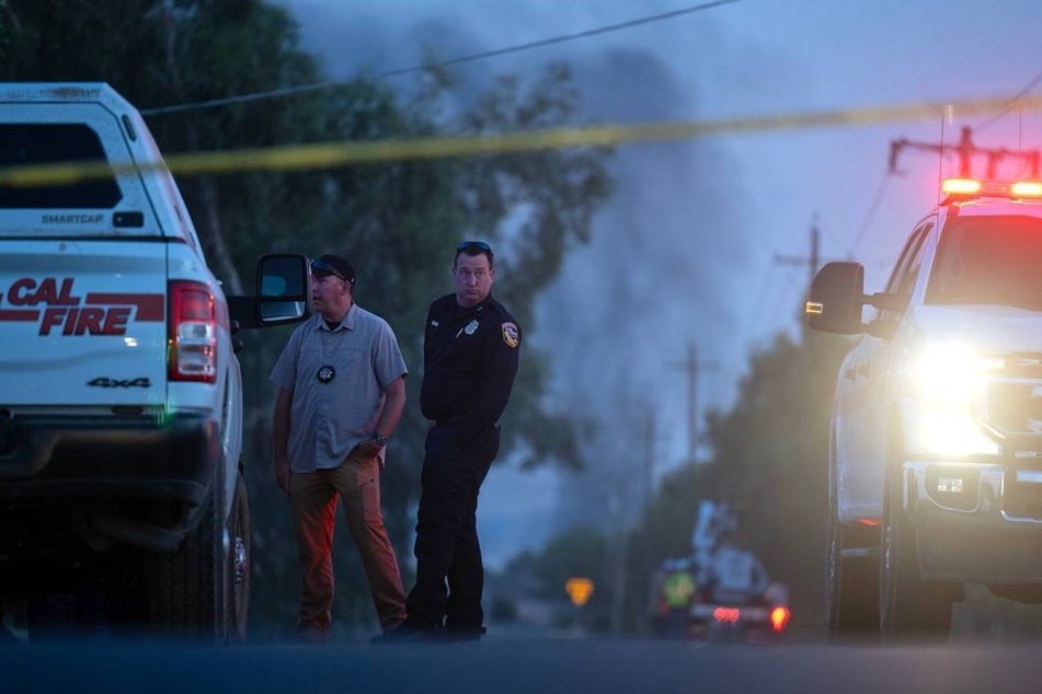 Emergency crews gather Tuesday at Highway 16 and County Road 86A in Esparto, California, near the location of a fireworks explosion at a warehouse on County Road 23.