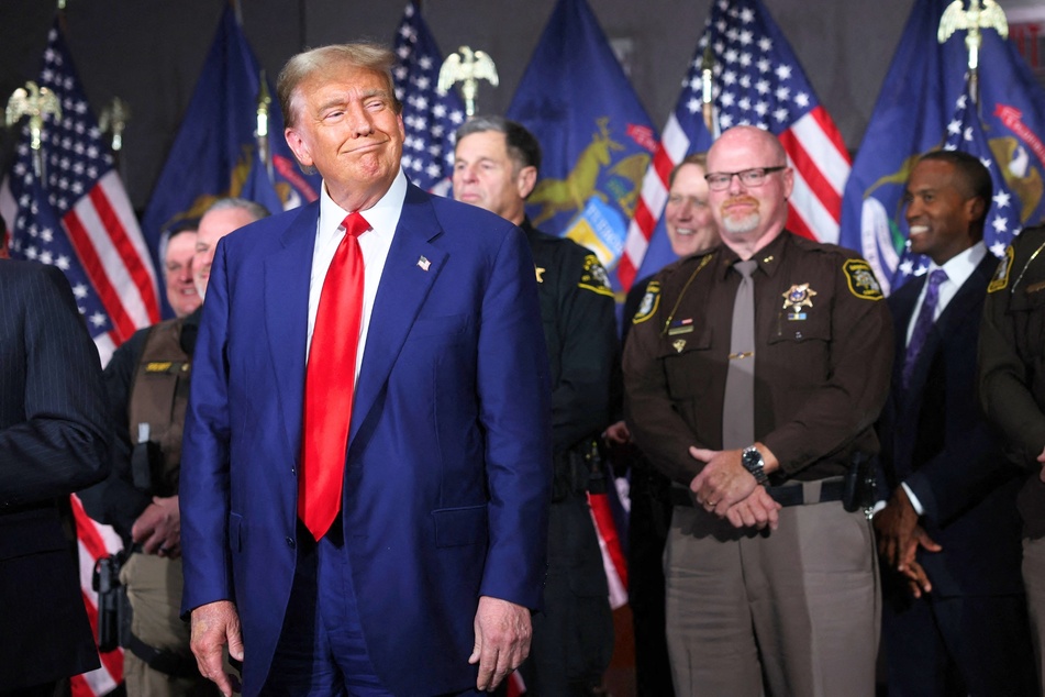 Former US President Donald Trump (front) speaking at a campaign event in Grand Rapids, Michigan on Tuesday.